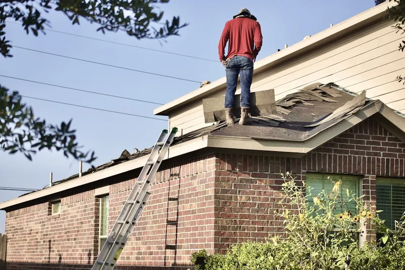 Professional roofer working on a residential roof in Baileys Corner